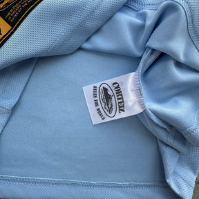Camisa Corteiz “Panel Sky Blue Jersey”