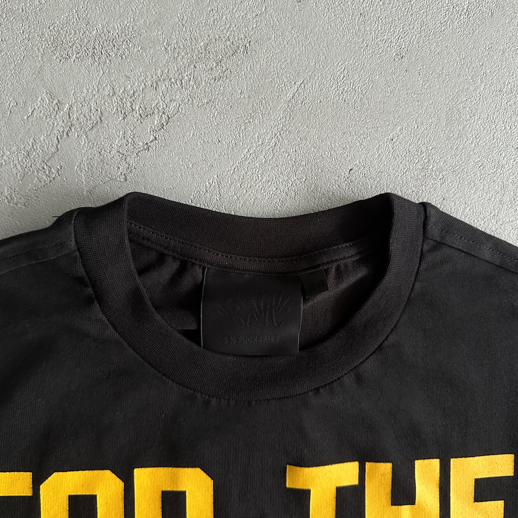 aCamisa Syna World “Wages”