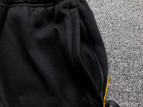 Conjunto Nocta x Nike “University Gold”